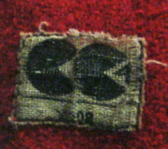 A surviving CC41 utility label sewn inside a red coat