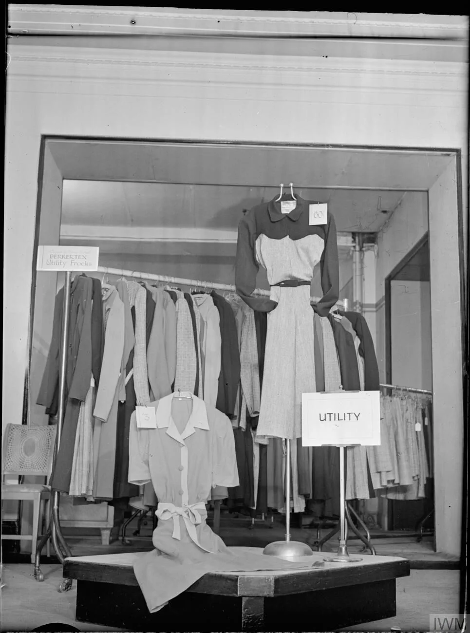 A 1942 shop display of utility clothing under a sign reading UTILITY